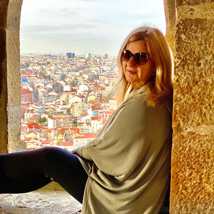 Traveler exploring the tiled facades and hillside streets of Lisbon, Portugal